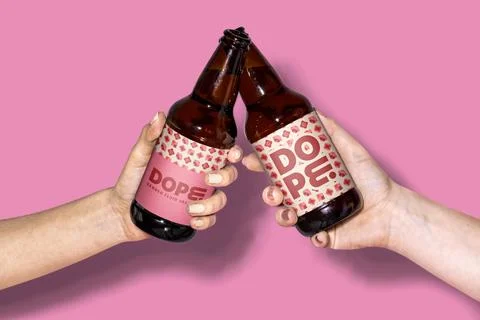 Clinking beer bottles, geometric pattern labels Stock Photos