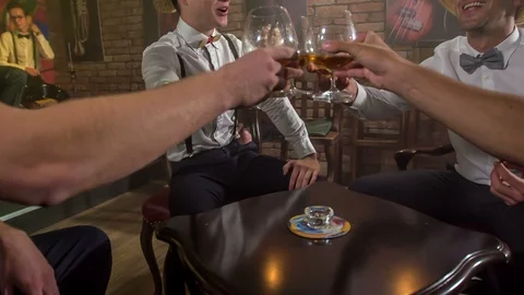 Clinking glasses filled with whiskey  Stock Footage 112186315