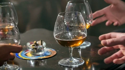 Clinking glasses filled with whiskey Stock Footage 112198358