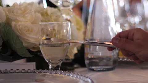 Clinking glasses of wine at wedding reception to encourage the bride and groom	 Video stock 122595142