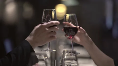 Clinking with wine glasses in a restaurant in the evening Stock Footage 61368558