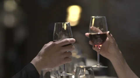 Clinking with wine glasses in a restaurant in the evening Stock Footage 61368667