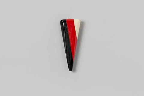 Clip of black, red and white leg (?), Art DÃ co, pointed triangle shape wi.. Stock Photos