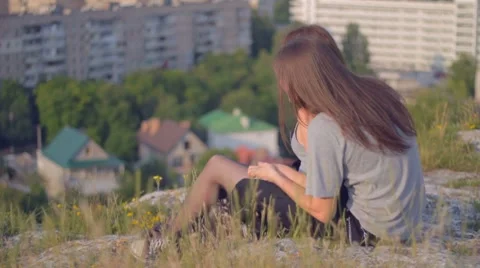 CLIP EDIT Happy young couple sitting on slope gently touching each other Stock Footage 8366953
