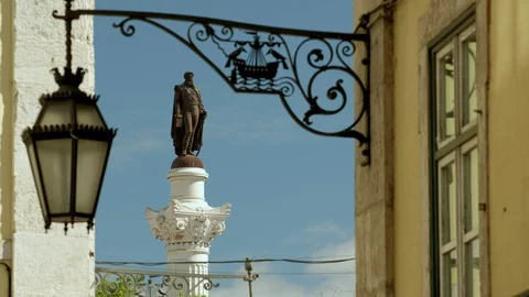 Clip looking down Rua Carmo towards the statue of Pedro IV in Rossio Square Stock Footage 120067120