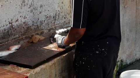 A clip of a man cleaning fish.  Stock-Footage 246771544