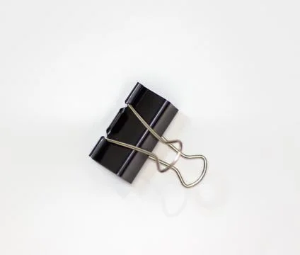 Clip for papers. Binding of papers, office supplies. Binder for papers on a Stock Photos