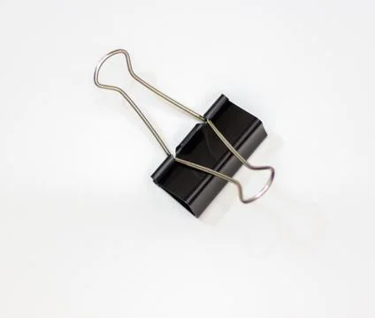 Clip for papers. Binding of papers, office supplies. Binder for papers on a Stock Photos