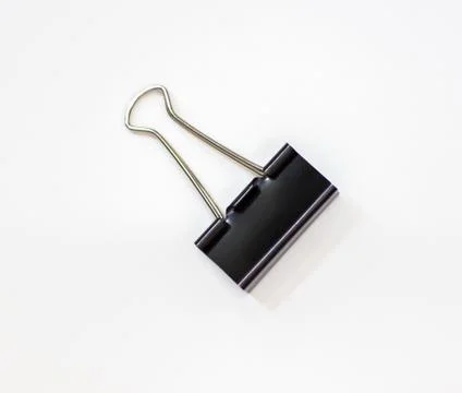 Clip for papers. Binding of papers, office supplies. Binder for papers on a Stock Photos