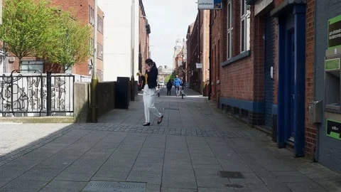 A clip of pedestrians walking down on Millstone Lane Leicester City, UK. Video stock 241099686