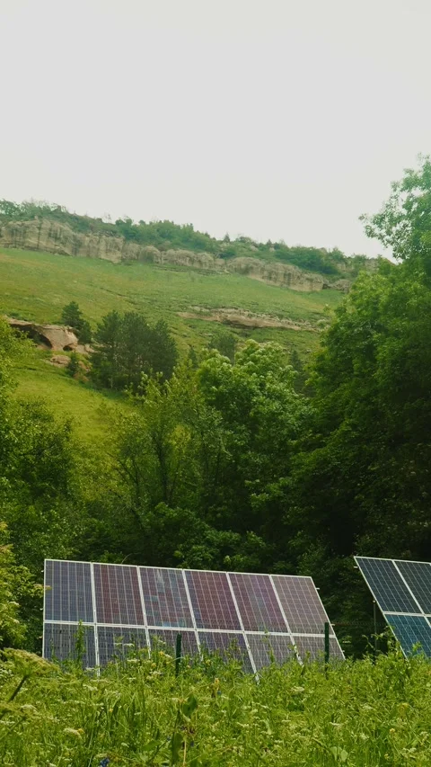 This clip showcases a solar panel array set against a vibrant green field and Stockbeeldmateriaal 312631826
