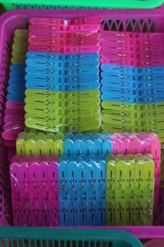 Clip Strips multi-colored clothes in the basket. Stock Photos
