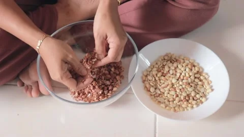 Clip of a woman's hands as she peels the nuts  Stock Footage 158048347