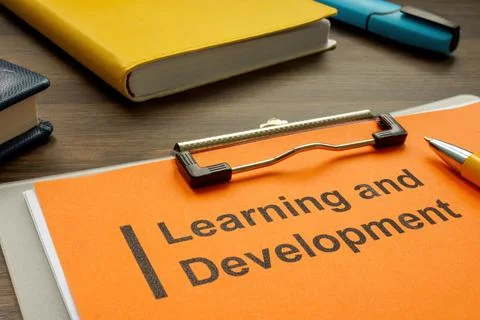 Clipboard with learning and development plan on the desk. Stock Photos