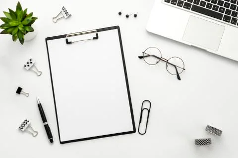 Clipboard mockup flat lay frame with laptop, notebook and accessories. Top view Stock Photos