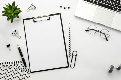 Clipboard mockup flat lay frame with laptop, notebook and accessories. Top view Stock Photos