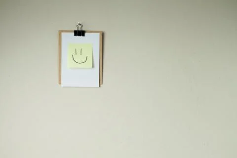 Clipboard with post it notes and smile on the wall. smile concept. clipboard  Stock Photos