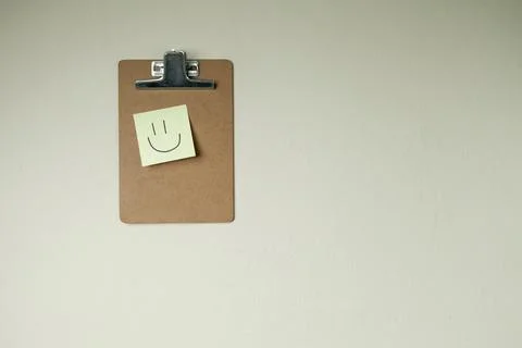 Clipboard with post it notes and smile on the wall. smile concept. clipboard  Stock Photos