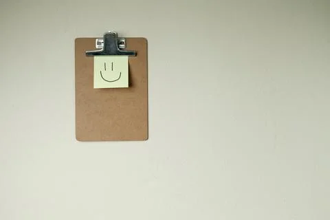 Clipboard with post it notes and smile on the wall. smile concept. clipboard  Stock Photos