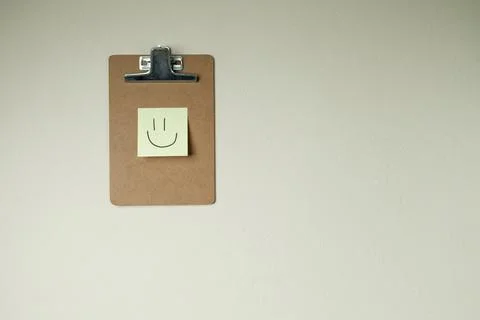 Clipboard with post it notes and smile on the wall. smile concept. clipboard  Stock Photos