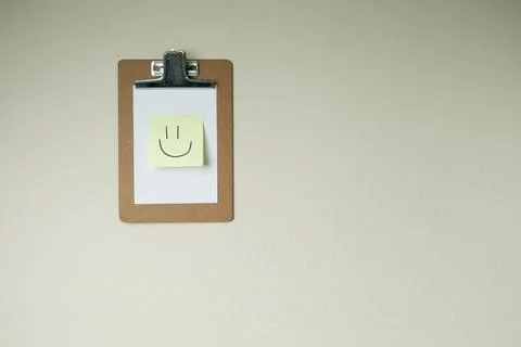 Clipboard with post it notes and smile on the wall. smile concept. clipboard  Stock Photos