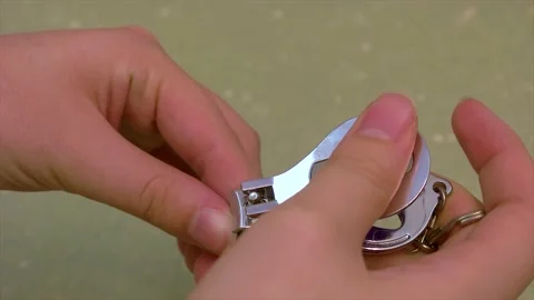Clipping a nail off an average looking thumb Stock Footage 132941129