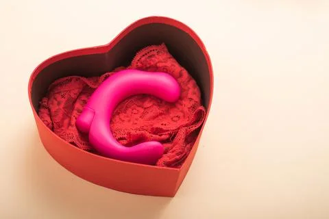 Clitoral vaginal vibrator and lace red women's panties in a box in the form of a Stock Photos