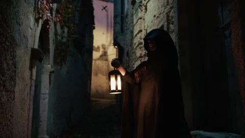 Cloaked Man Holding The Lantern Through a Veil of Night Stock Footage 301924628