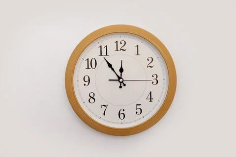 Clock 11.55 on a white background, space for text Stock Photos