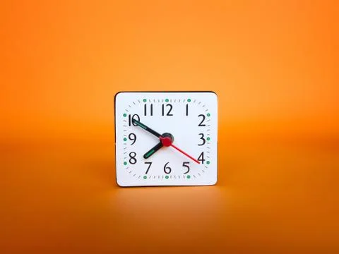 Clock on abstract orange background. Stock-Fotos