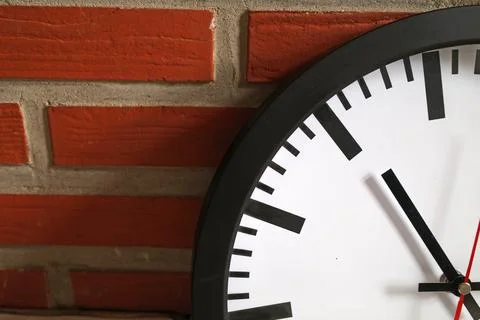 Clock against a brick wall Stock Photos