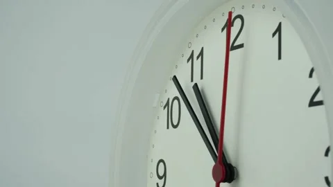 Clock against white background hanging on the wall. Stock Footage 230114680