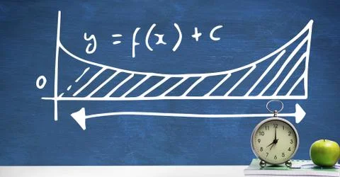 Clock and apple on Desk foreground with blackboard graphics of equations formula 写真素材