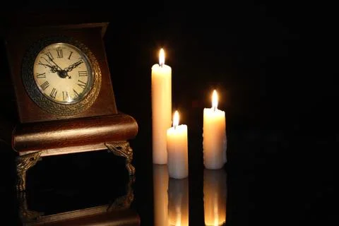 Clock and candles Stock Photos