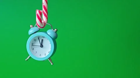 Clock and candy canes hang in a simple setup with bright colors Stock Footage 340462842