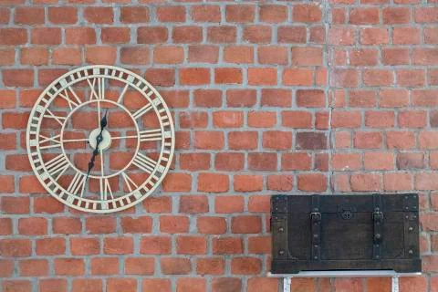 Clock and chest on brick wall background Stock Photos
