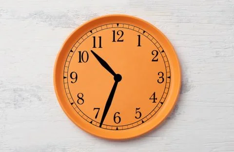 Clock and dial on a plastic orange plate Stock Photos