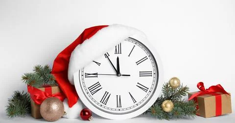 Clock and festive decor on white background. New Year countdown 스톡 사진