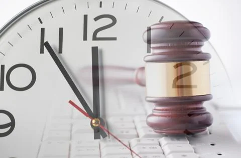 Clock and gavel on computer keyboard Stock Photos