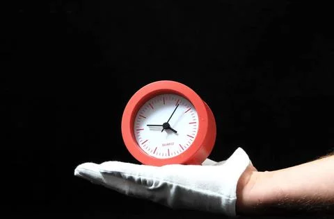 Clock And an Hand Clock And an Hand on a Black Background Copyright: xZoon... Foto stock