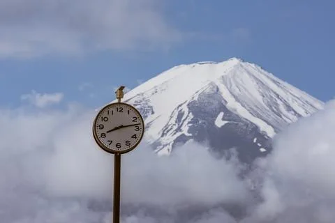 A  clock and a landscape view of Mount Fuji Stock Photos