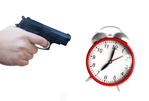 Clock and pistol Stock Photos
