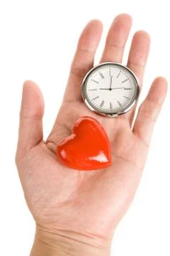 Clock and Red Heart Stock-Fotos