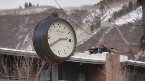 Clock and snow clad mountain in background Video stock 84506752