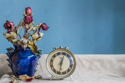 Clock and a vase on a white background. Stock Photos