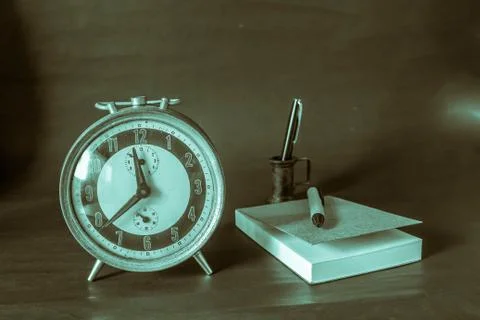 Clock and writing on background. Stock Photos