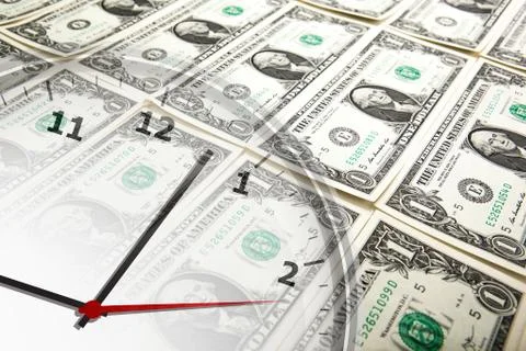 Clock on the background of banknotes dollars Stock Photos