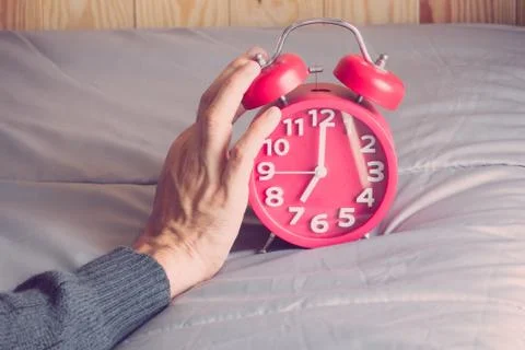 Clock on the bed in morning. Foto stock