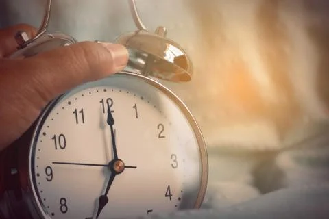 Clock on the bed in the morning. Foto stock