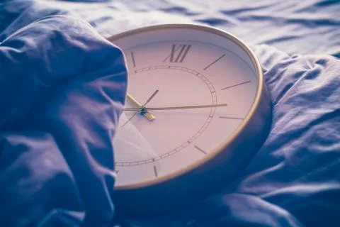 Clock in bed Stock Photos